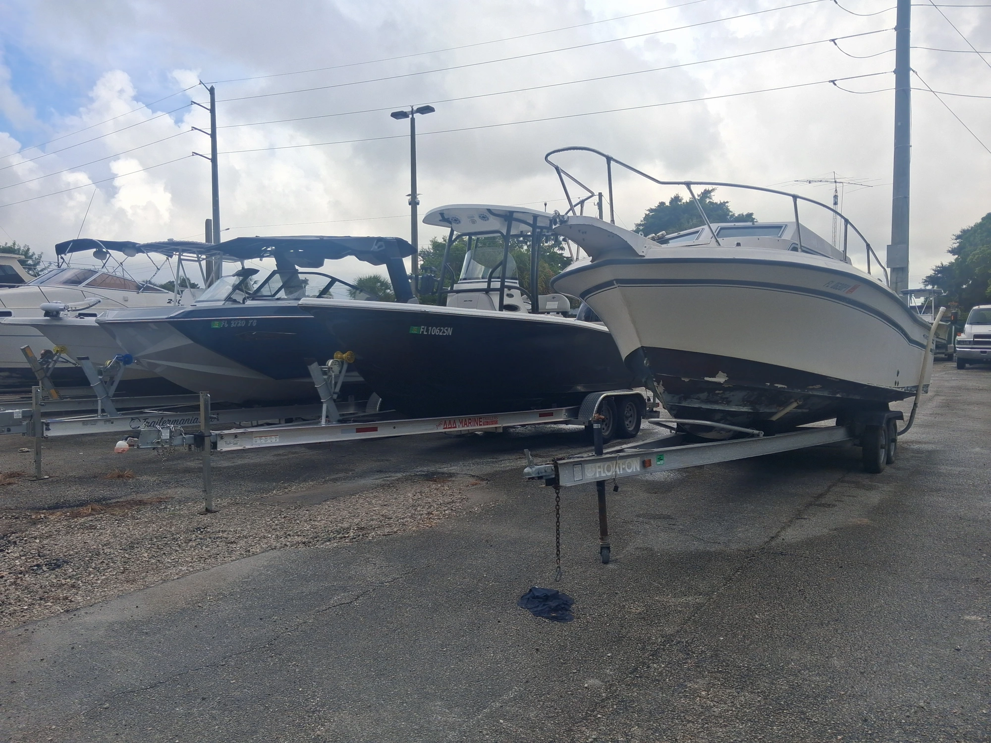 Boats on trailers parked side by side