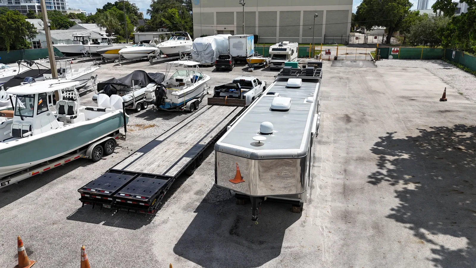Boats, flatbed trailer and enclosed cargo trailer parked at 3551 Avenue E
