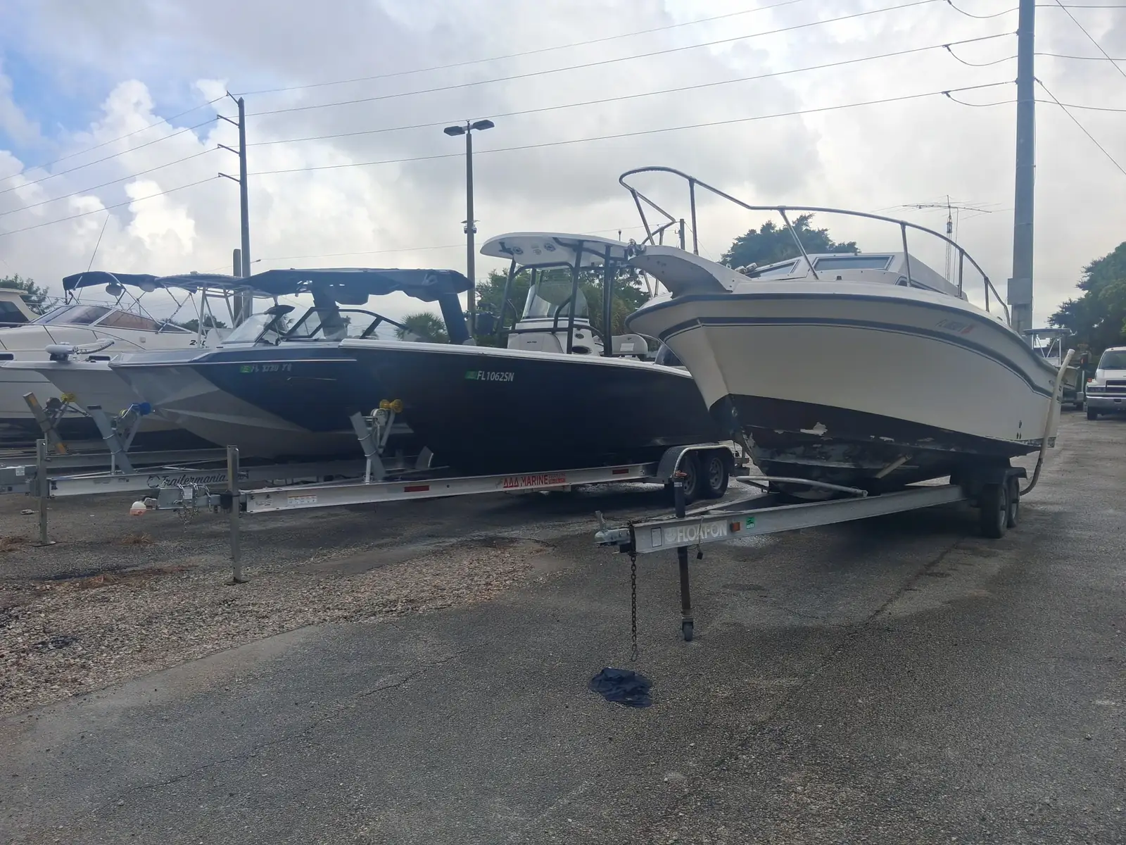Boats on trailers parked side by side