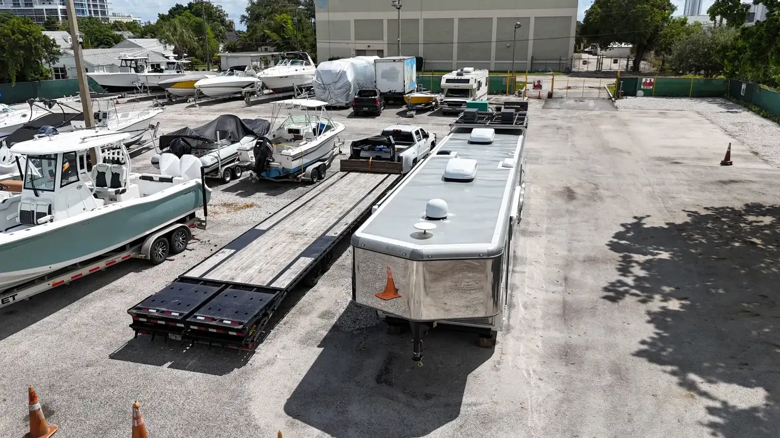 Boats, flatbed trailer and enclosed cargo trailer parked at 3551 Avenue E